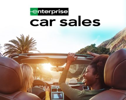 enterprise car sales image with two women driving on a sunny day
